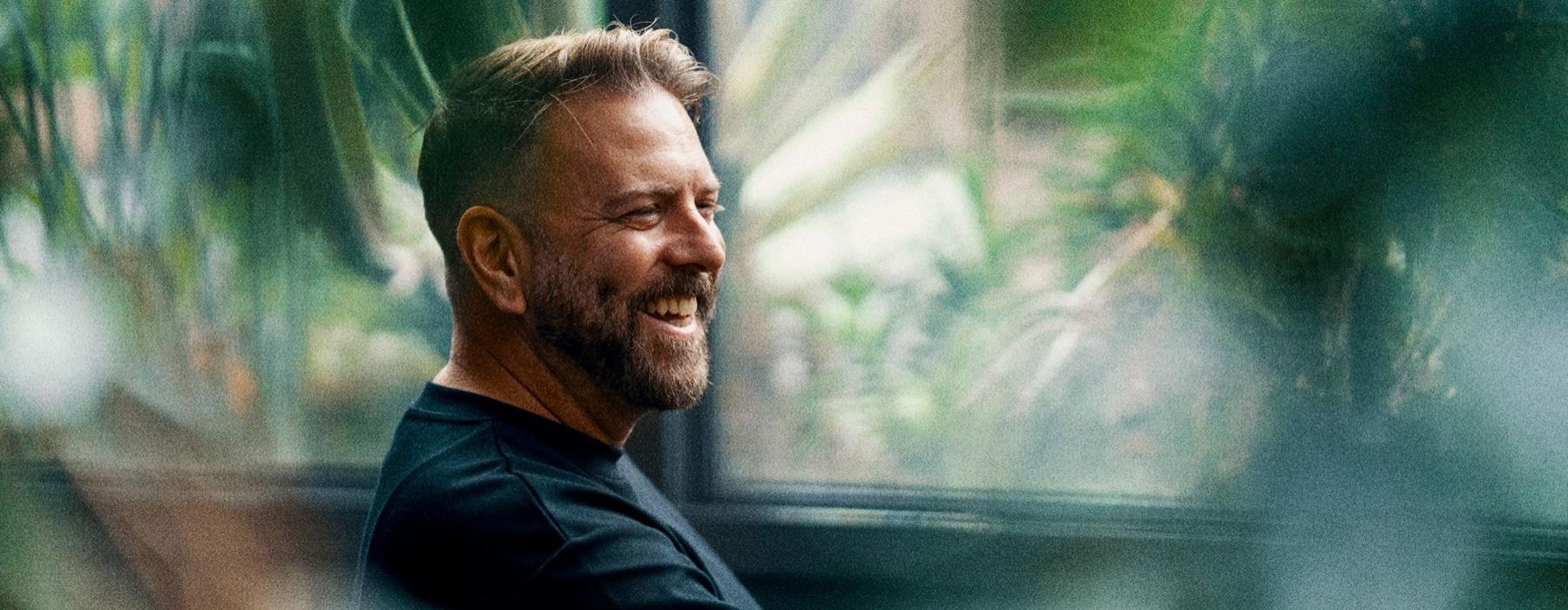 a man smiling with a beard