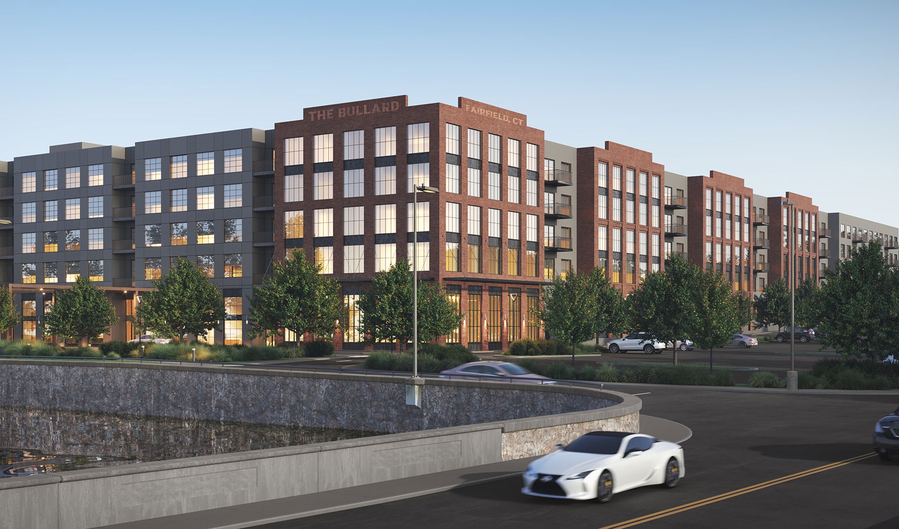 a large building with a car driving on a road